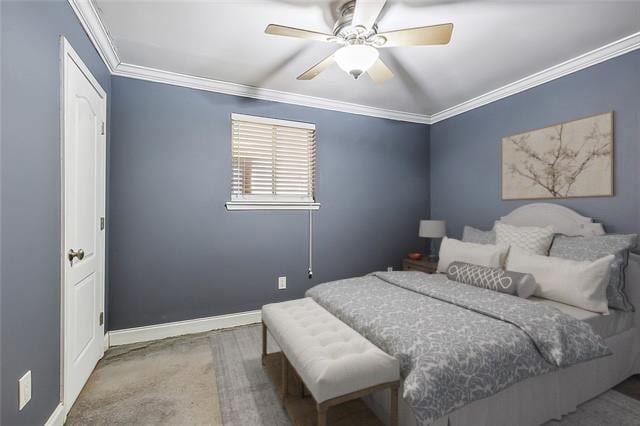 bedroom featuring ceiling fan, crown molding, and carpet