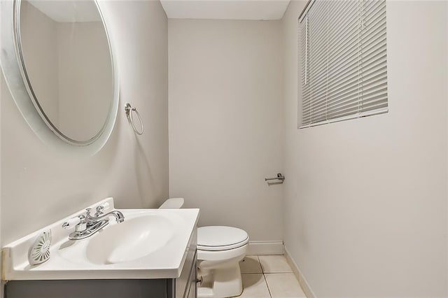 bathroom featuring tile patterned floors, vanity, and toilet