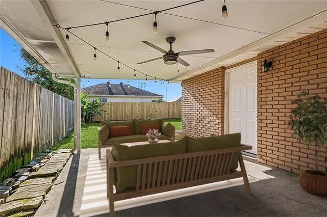 view of patio with outdoor lounge area and ceiling fan