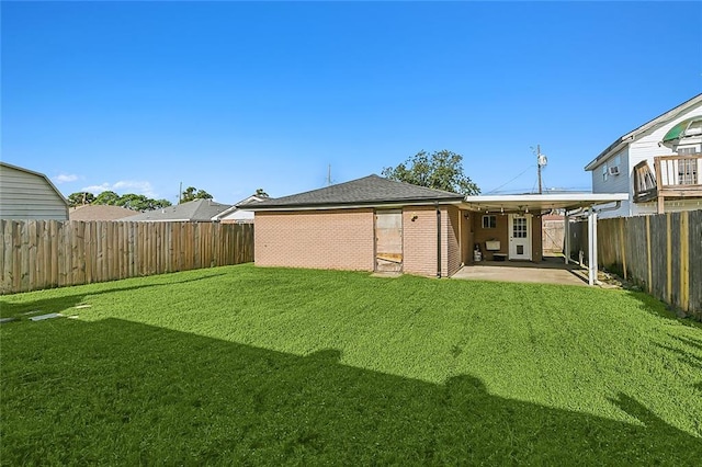 back of house with a patio and a yard