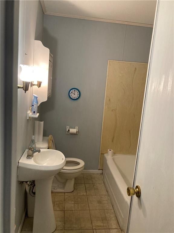 bathroom with crown molding and toilet