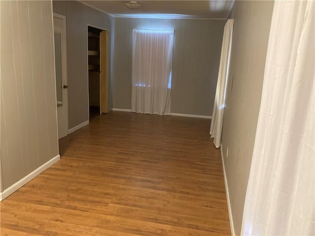 interior space featuring light wood-type flooring and ornamental molding