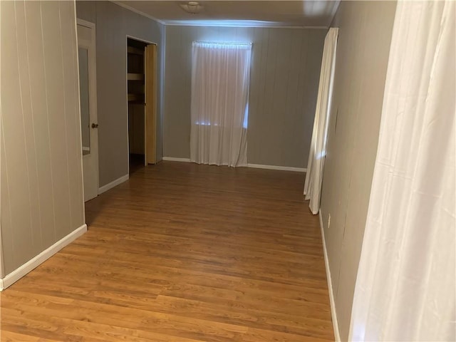 3008 Lake Villa Dr, Metairie, LA 70002 - hall with light wood finished floors, wood walls, baseboards, and ornamental molding