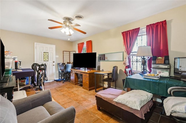 tiled office space featuring ceiling fan