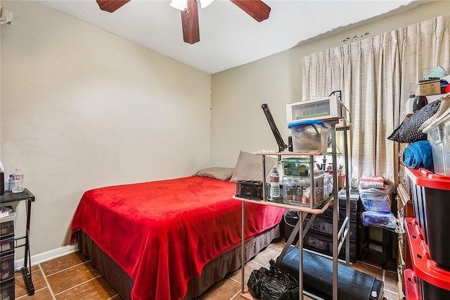 bedroom with tile patterned flooring, ceiling fan, and multiple windows