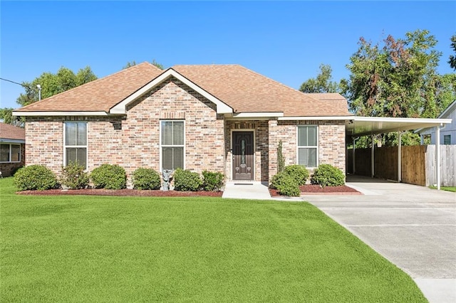 view of front of property with a front yard and a carport