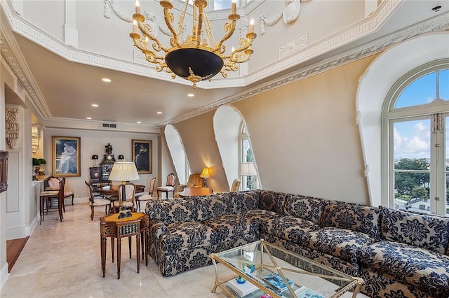 living room with a towering ceiling, ornamental molding, and a chandelier