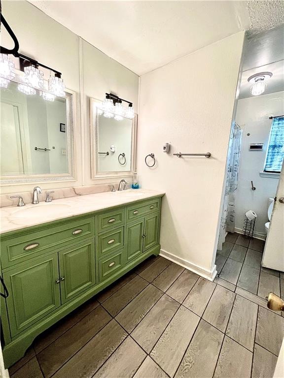 bathroom with walk in shower, vanity, toilet, and wood-type flooring