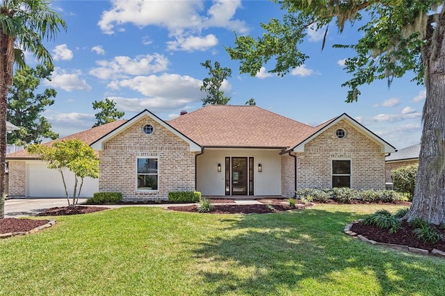 single story home with a front yard and a garage