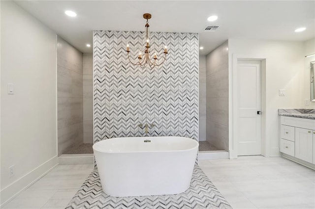 bathroom with vanity, a chandelier, and plus walk in shower