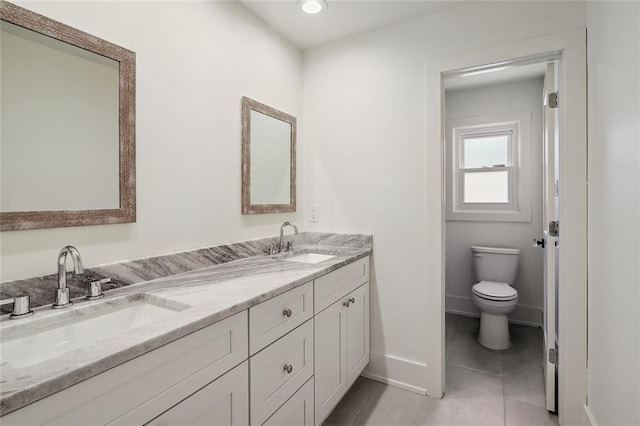 bathroom with vanity, toilet, and tile patterned floors