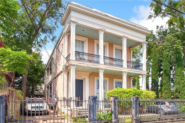 greek revival inspired property with a balcony