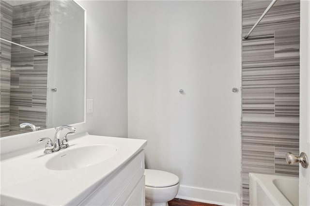 1524 Euterpe St Unit A, New Orleans, LA 70130 - bathroom featuring vanity, toilet, bathtub / shower combination, and baseboards