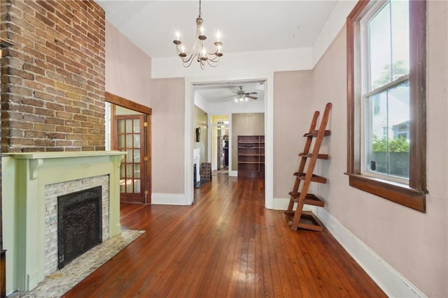 hallway featuring an inviting chandelier and dark wood-type flooring