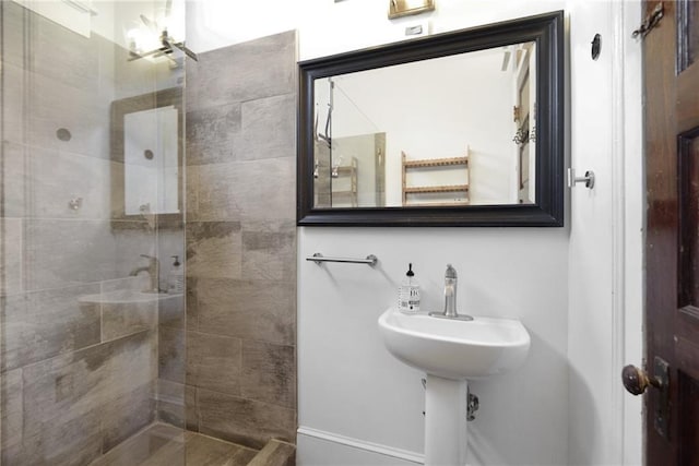 bathroom with a tile shower