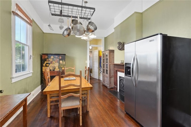 dining space with dark wood-type flooring and a notable chandelier