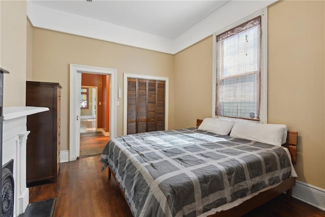 bedroom with dark wood-type flooring and a closet