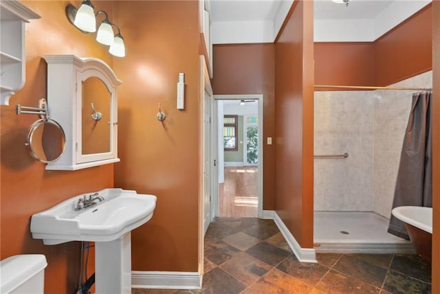 bathroom with curtained shower and toilet