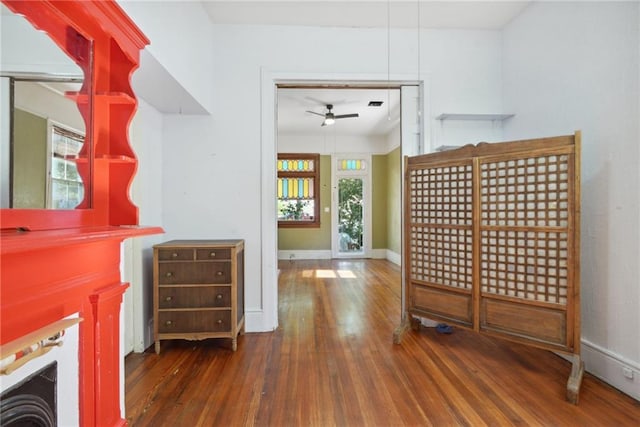 interior space with dark wood-type flooring and ceiling fan