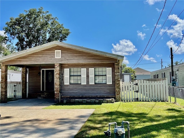 view of front of property with a carport, fence, and a front lawn
