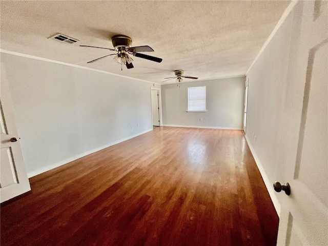 spare room featuring ceiling fan, hardwood / wood-style flooring, crown molding, and a textured ceiling