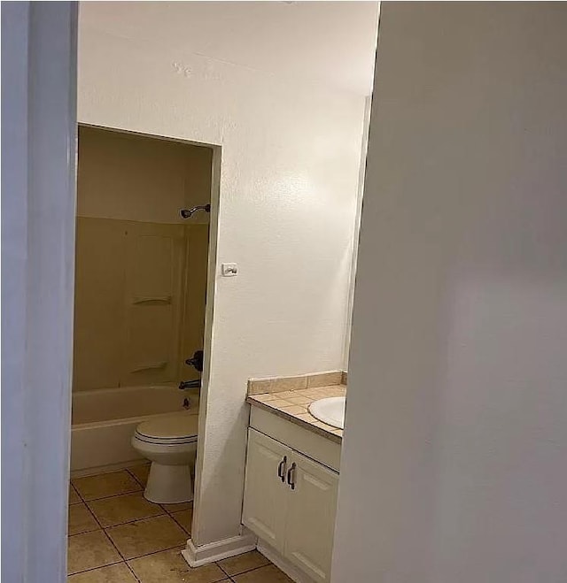 full bathroom featuring  shower combination, vanity, tile patterned flooring, and toilet