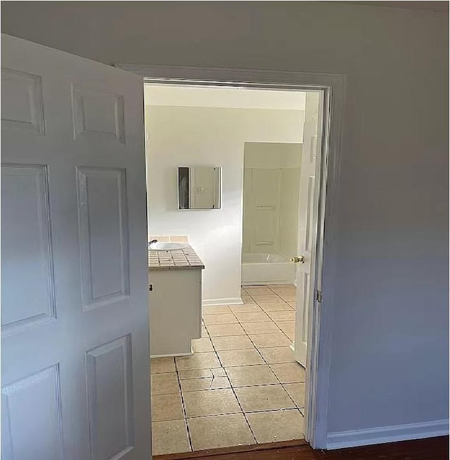 hall featuring light tile patterned flooring