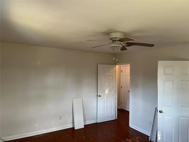 unfurnished bedroom with dark wood-type flooring and ceiling fan