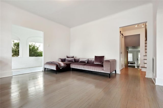 living room with hardwood / wood-style flooring and a barn door