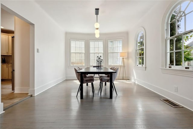 dining space with dark wood-type flooring