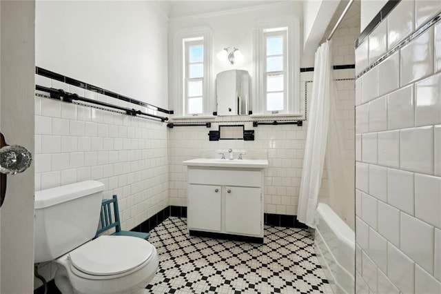 full bathroom with tile walls, vanity, toilet, and shower / bathtub combination with curtain