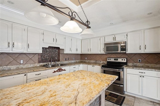 kitchen featuring sink, white cabinetry, backsplash, appliances with stainless steel finishes, and decorative light fixtures