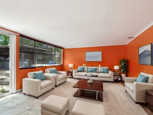 tiled living room with plenty of natural light and crown molding