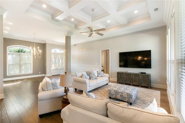 living room with ceiling fan with notable chandelier, crown molding, hardwood / wood-style floors, and ornate columns