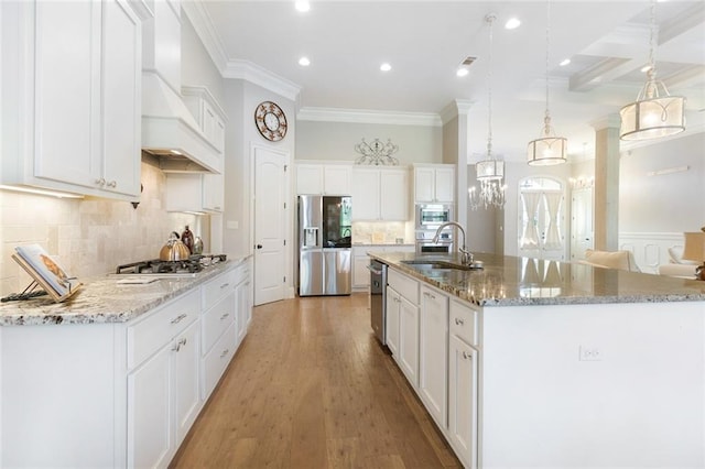 kitchen with a spacious island, pendant lighting, stainless steel appliances, and white cabinets