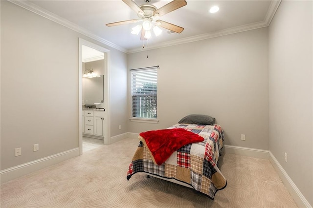 carpeted bedroom with ceiling fan, ensuite bath, and crown molding