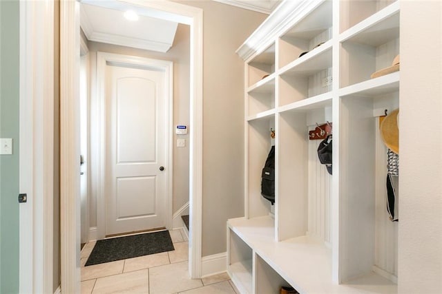 mudroom with ornamental molding and light tile patterned floors