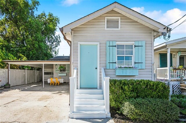 bungalow-style home featuring a porch and a carport