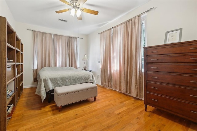 bedroom with light hardwood / wood-style floors and ceiling fan