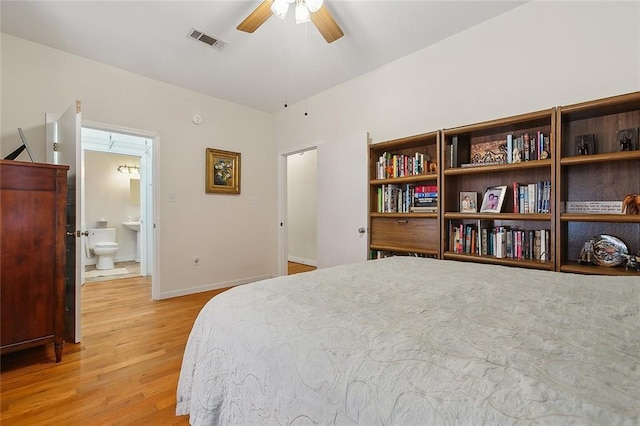 bedroom featuring light hardwood / wood-style flooring, ceiling fan, and ensuite bathroom