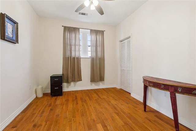 unfurnished room featuring light wood-type flooring and ceiling fan