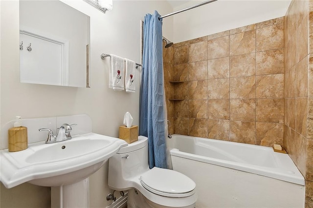 full bathroom with sink, shower / tub combo, and toilet