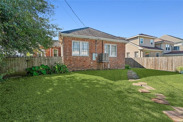 rear view of house with a yard