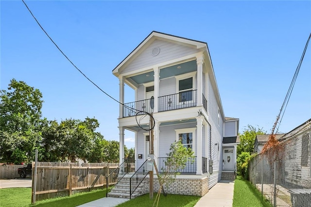 view of front of house featuring a balcony and a porch