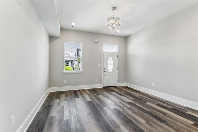 foyer entrance featuring dark hardwood / wood-style floors and a chandelier