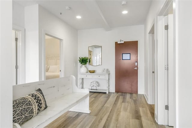 corridor with light hardwood / wood-style floors