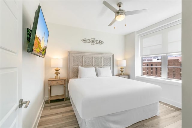 bedroom with ceiling fan and light hardwood / wood-style floors