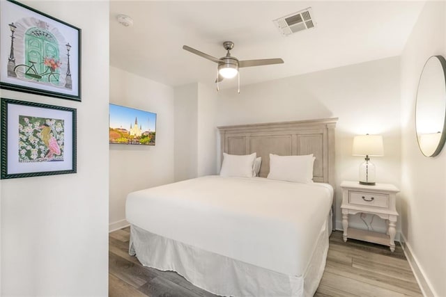 bedroom with ceiling fan and light wood-type flooring