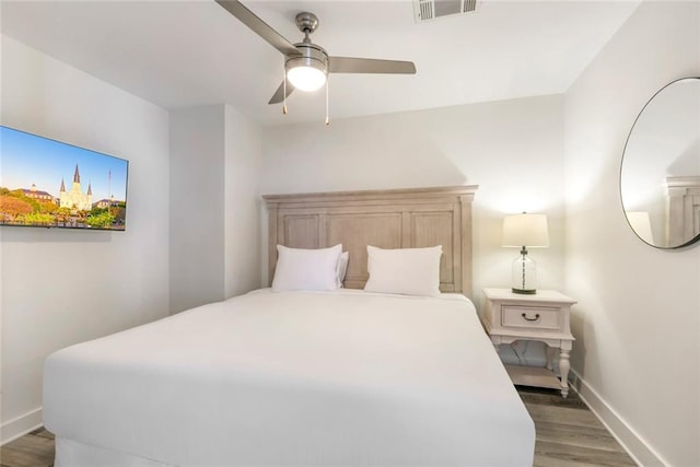 bedroom with ceiling fan and hardwood / wood-style floors