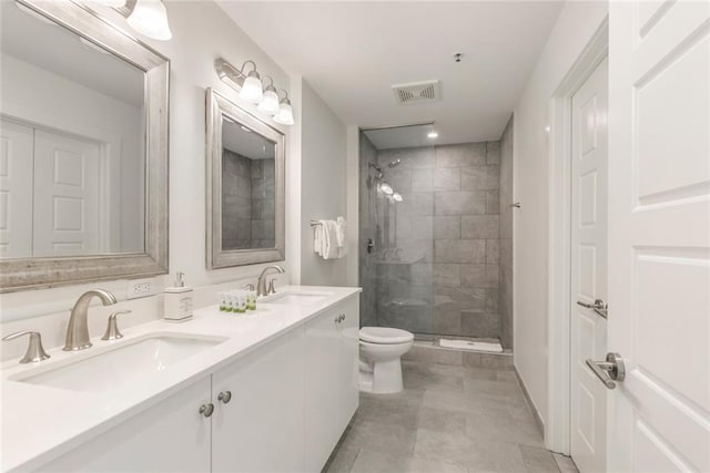 bathroom featuring an enclosed shower, vanity, and toilet